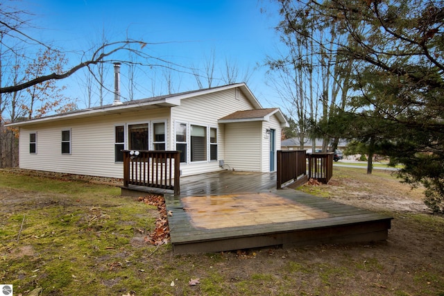 back of house featuring a deck