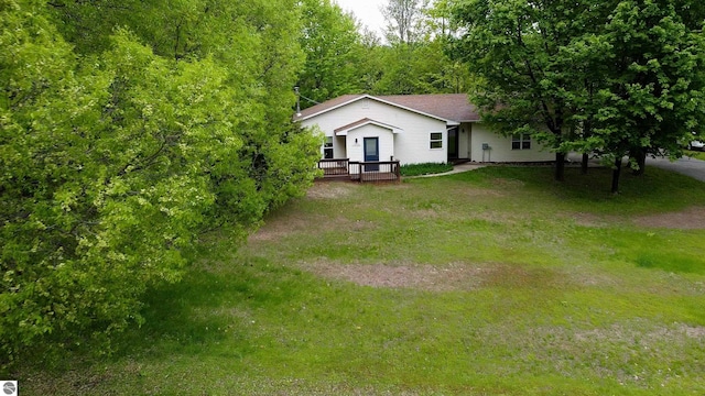 12110 Jonathan Dr, Rapid City, MI 49676 - view of front facade featuring a wooden deck