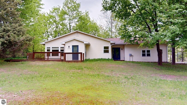12110 Jonathan Dr, Rapid City, MI 49676 - ranch-style home featuring a deck and a front lawn