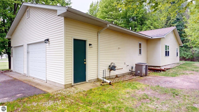 12110 Jonathan Dr, Rapid City, MI 49676 - view of home's exterior featuring a garage