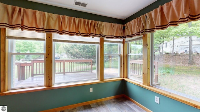 12110 Jonathan Dr, Rapid City, MI 49676 - unfurnished sunroom with wood finished floors and baseboards