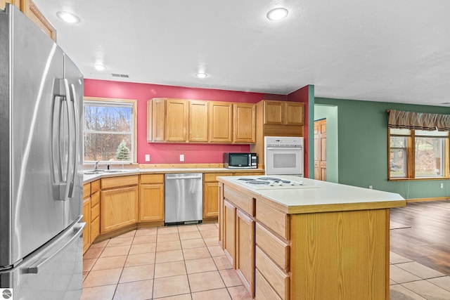 kitchen featuring a healthy amount of sunlight, visible vents, light countertops, and appliances with stainless steel finishes