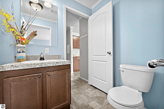 bathroom featuring visible vents, ornamental molding, toilet, a textured ceiling, and vanity