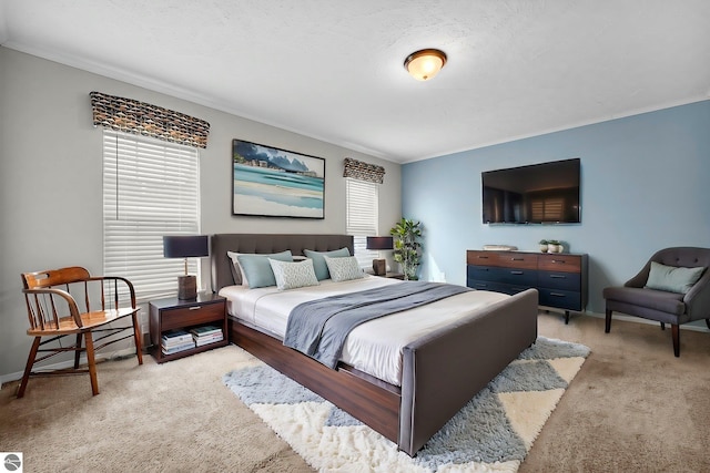 carpeted bedroom with baseboards and ornamental molding