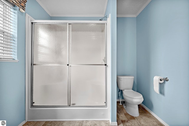 bathroom with a shower stall, baseboards, ornamental molding, and toilet
