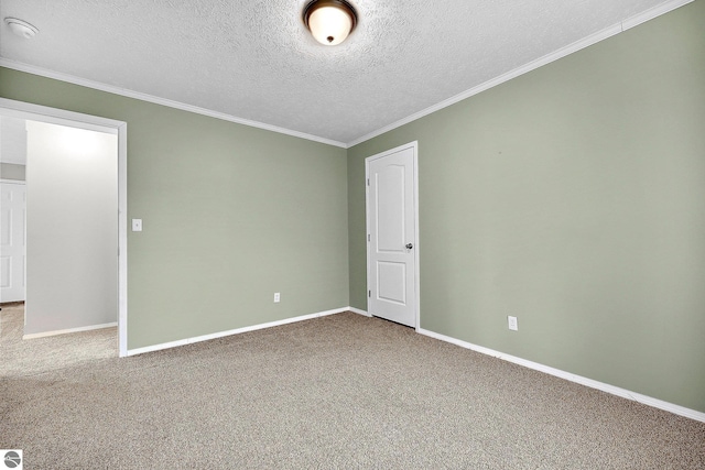 empty room with carpet flooring, baseboards, crown molding, and a textured ceiling