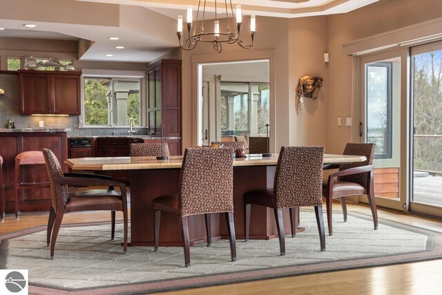 6579 Woods Creek Dr, Charlevoix, MI 49720 - dining room featuring recessed lighting, a chandelier, and light wood-style floors