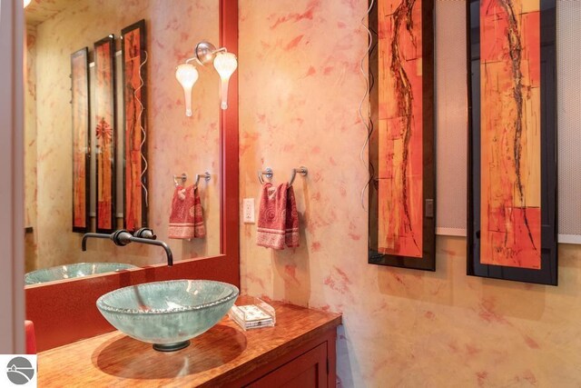 6579 Woods Creek Dr, Charlevoix, MI 49720 - bathroom with wallpapered walls and vanity