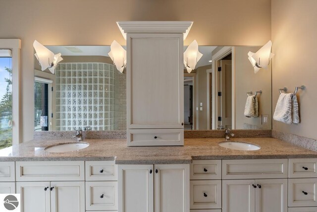 6579 Woods Creek Dr, Charlevoix, MI 49720 - bathroom featuring a sink and double vanity