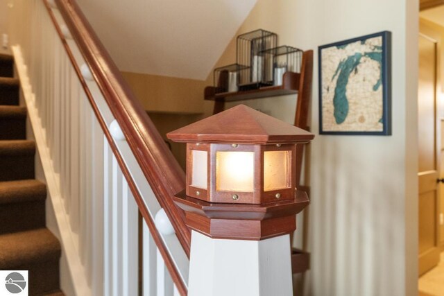 6579 Woods Creek Dr, Charlevoix, MI 49720 - staircase featuring lofted ceiling