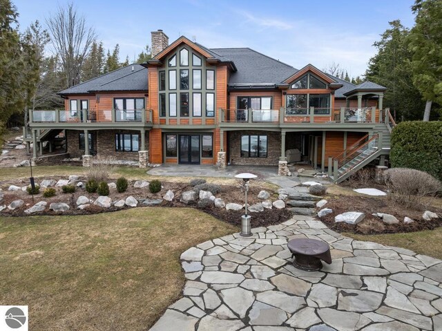 6579 Woods Creek Dr, Charlevoix, MI 49720 - back of house featuring french doors, a patio, a chimney, and stairway