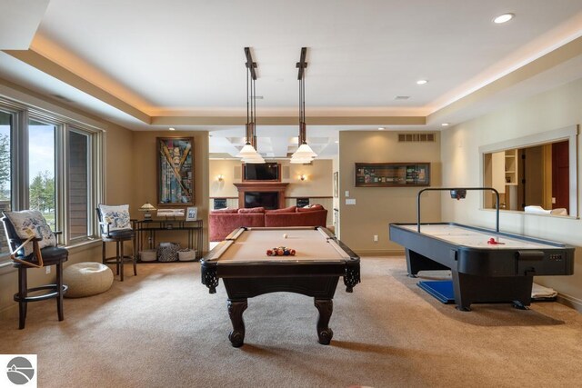 6579 Woods Creek Dr, Charlevoix, MI 49720 - game room with a tray ceiling, light colored carpet, and visible vents