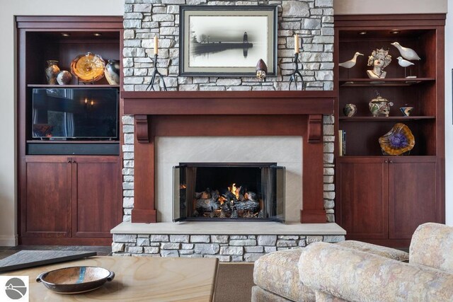 6579 Woods Creek Dr, Charlevoix, MI 49720 - living room with a warm lit fireplace