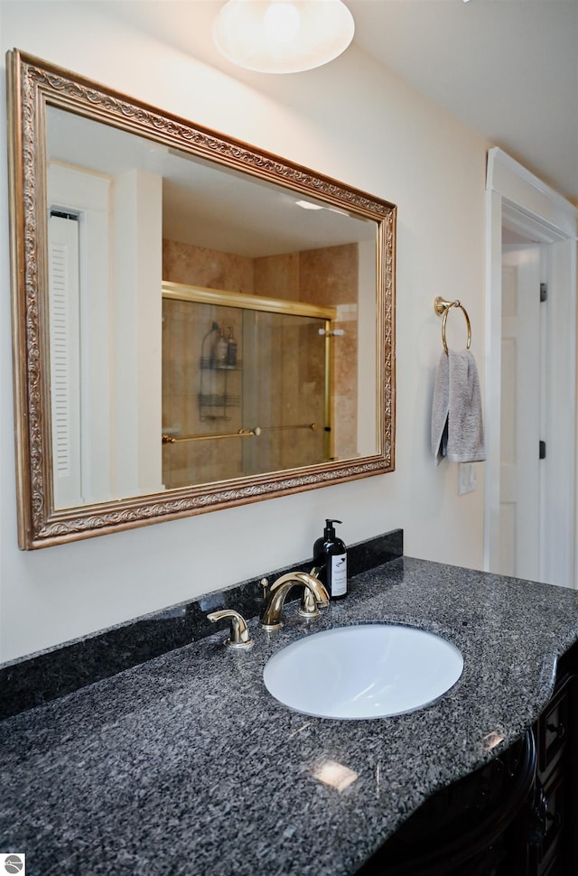 full bathroom with vanity and a stall shower