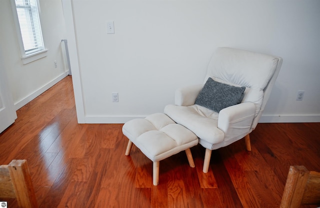sitting room with wood finished floors and baseboards