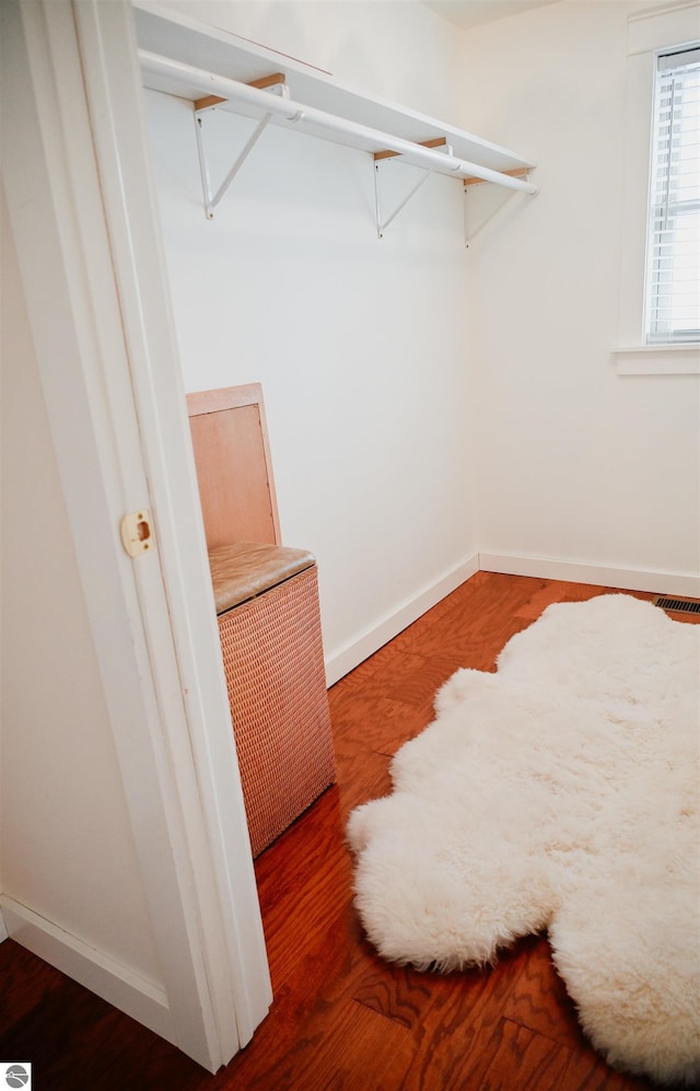 walk in closet featuring wood finished floors and visible vents