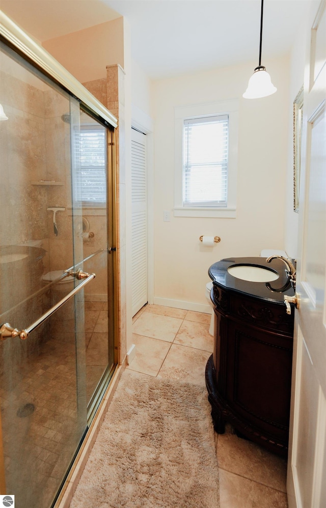 full bathroom with baseboards, a shower stall, tile patterned flooring, and vanity