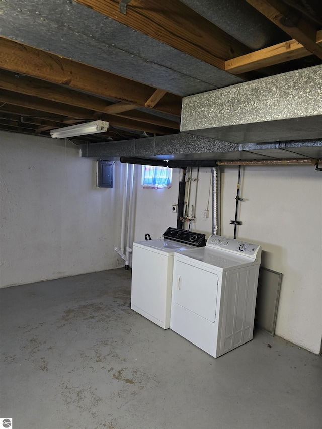 clothes washing area featuring electric panel, laundry area, and independent washer and dryer