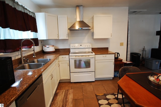 kitchen featuring white electric range, wall chimney range hood, white cabinetry, and dishwashing machine