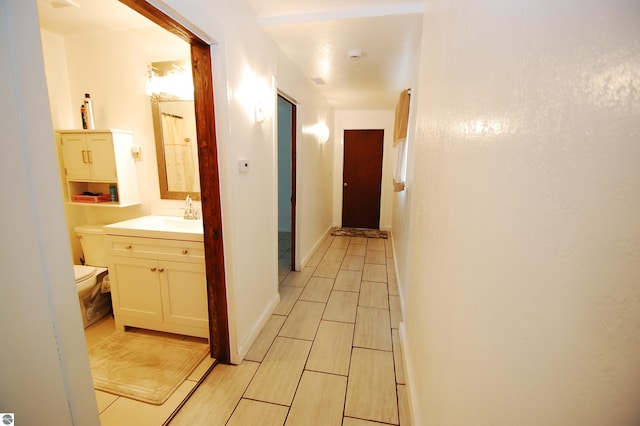 corridor with a sink and wood tiled floor
