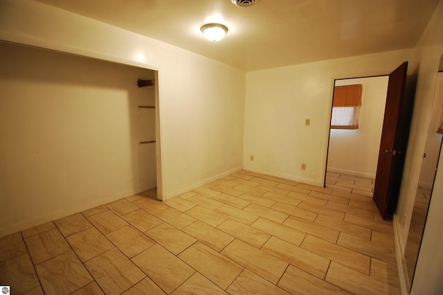 unfurnished room featuring baseboards