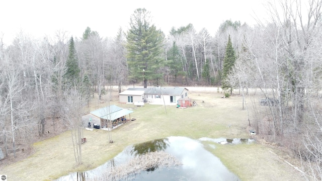 birds eye view of property featuring a water view and a view of trees