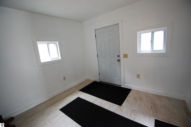 foyer entrance with a healthy amount of sunlight and baseboards