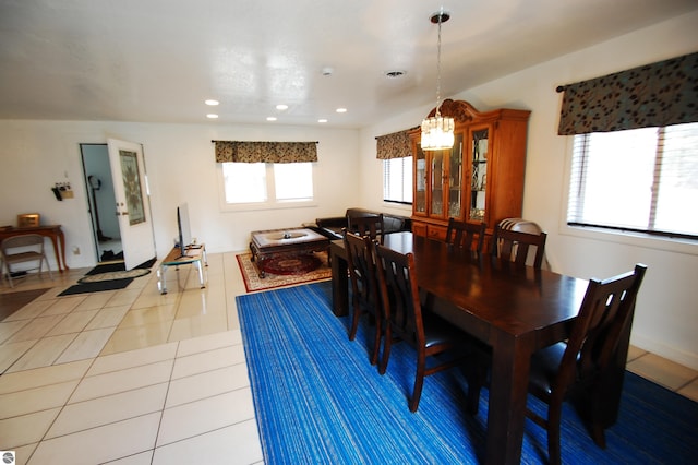 dining space featuring recessed lighting, tile patterned flooring, and an inviting chandelier