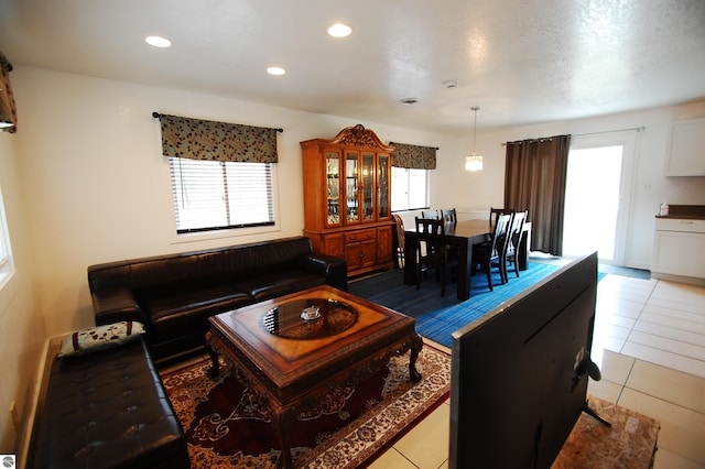 tiled living area featuring recessed lighting