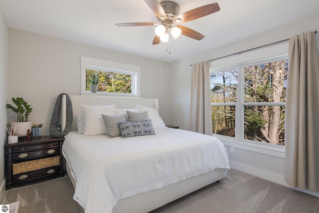 bedroom with multiple windows, carpet flooring, and a ceiling fan
