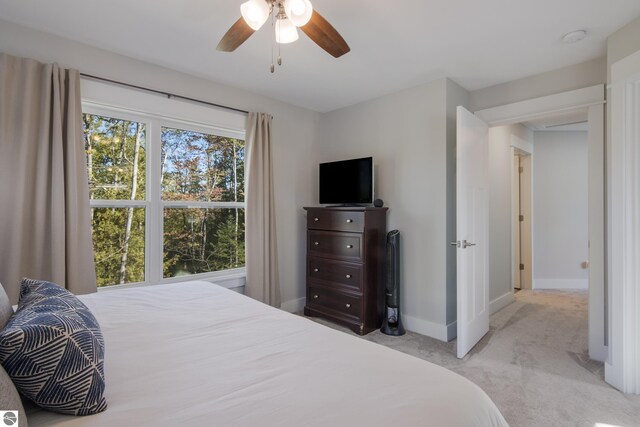 carpeted bedroom with baseboards and ceiling fan