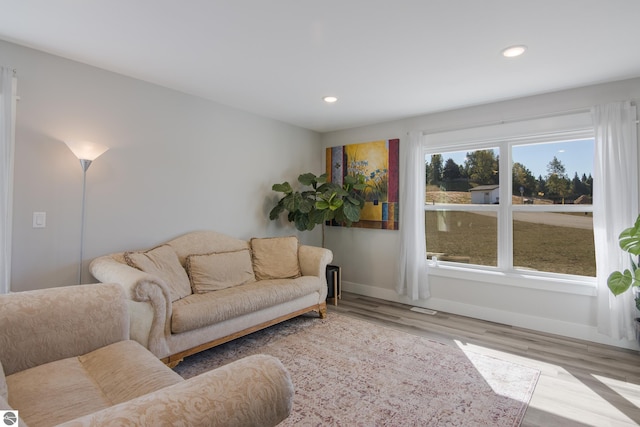 living area featuring recessed lighting, baseboards, and wood finished floors
