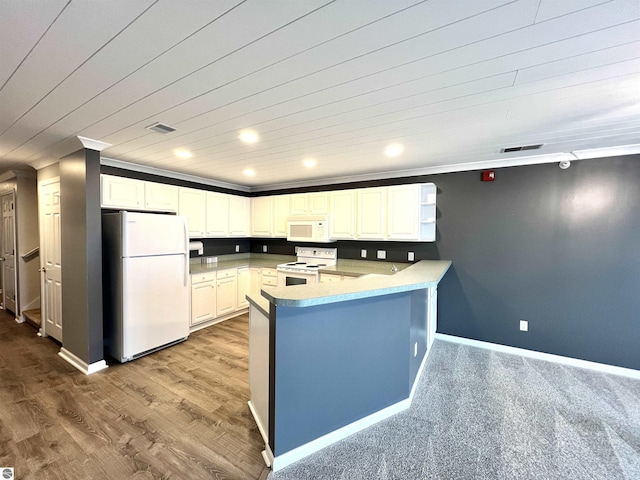 624 S Lake St, Cadillac, MI 49601 - kitchen with baseboards, white appliances, a peninsula, white cabinetry, and visible vents