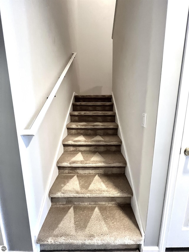 624 S Lake St, Cadillac, MI 49601 - staircase with baseboards
