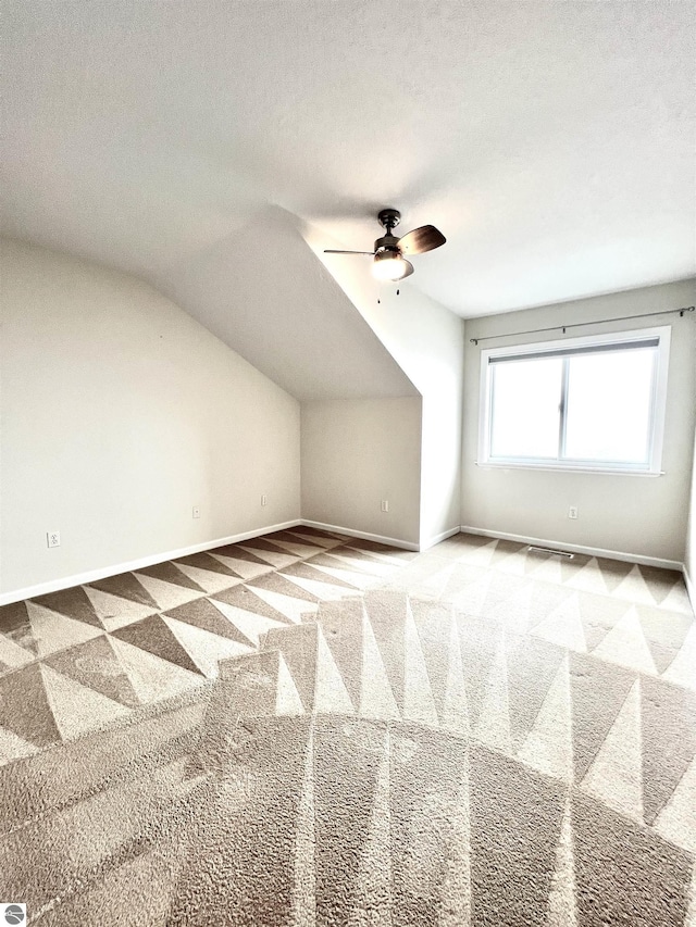 624 S Lake St, Cadillac, MI 49601 - additional living space featuring ceiling fan, baseboards, lofted ceiling, and carpet floors