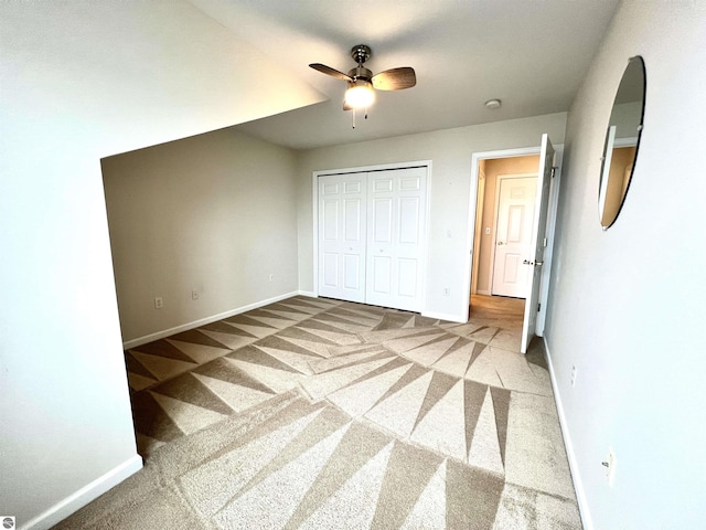 624 S Lake St, Cadillac, MI 49601 - unfurnished bedroom with a closet, baseboards, a ceiling fan, and carpet flooring