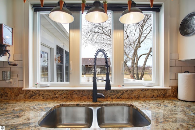 details featuring stone countertops and a sink