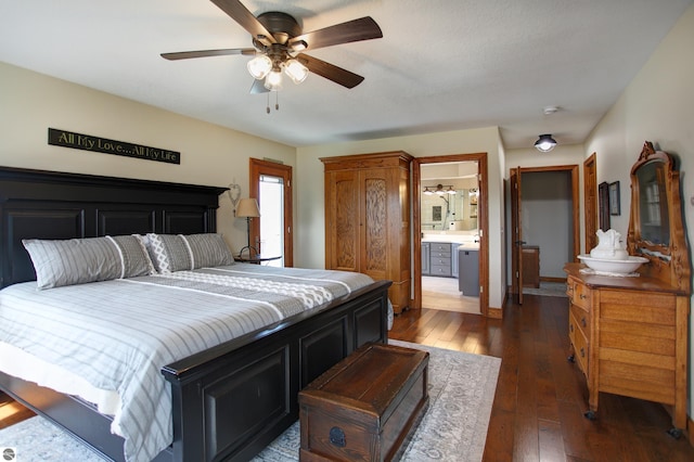 bedroom with dark wood-style flooring, a ceiling fan, and connected bathroom