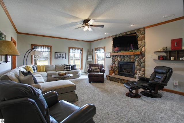 carpeted living area with ornamental molding, a textured ceiling, a ceiling fan, and a fireplace