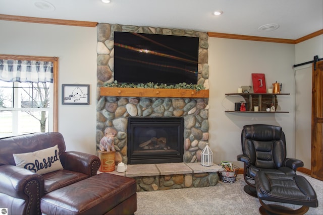living room featuring ornamental molding, a stone fireplace, carpet floors, recessed lighting, and a barn door