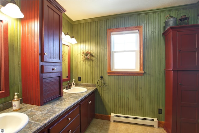 bathroom featuring tile patterned floors, double vanity, a baseboard radiator, and a sink