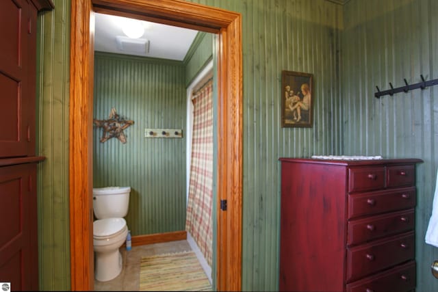 bathroom featuring tile patterned floors, baseboards, and toilet