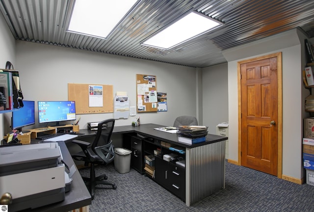 home office featuring dark colored carpet