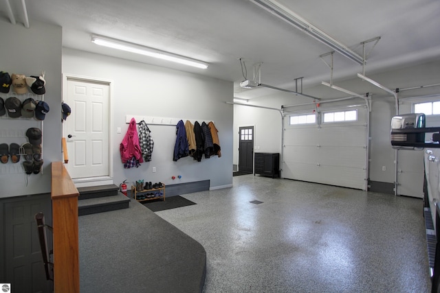 garage with a garage door opener and baseboards