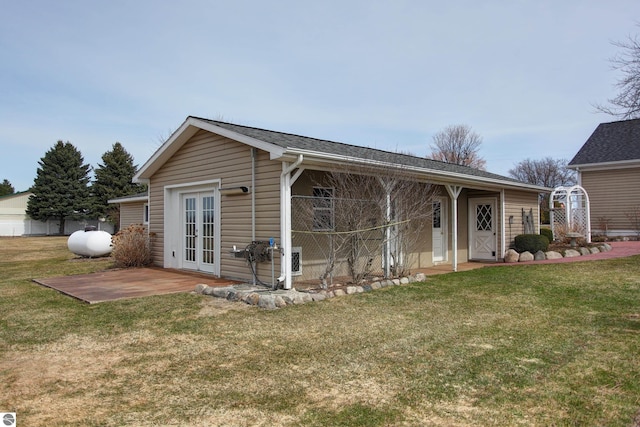 view of front facade with french doors, a patio area, and a front yard
