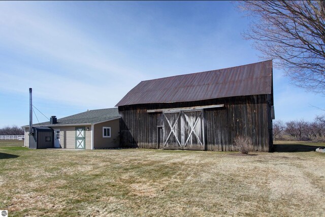 view of barn with a yard
