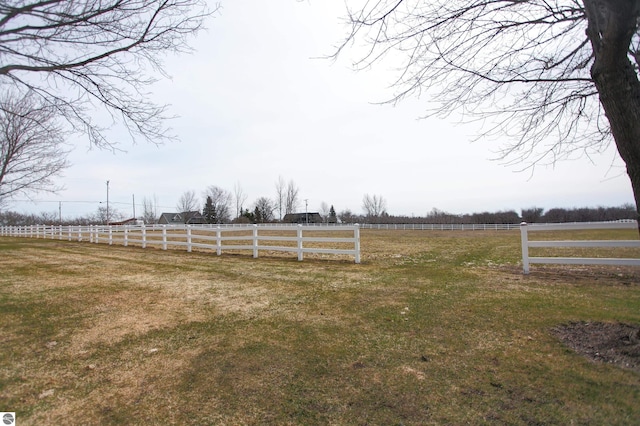 view of yard featuring fence and a rural view