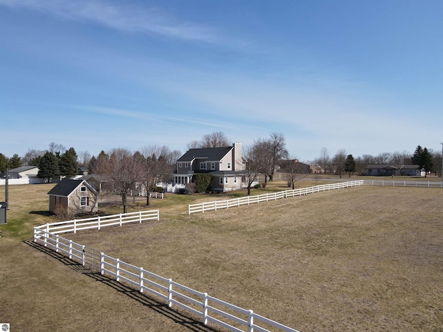 view of yard featuring a rural view and fence