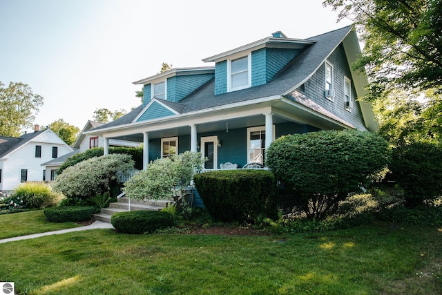 215 N Saint Marys St, Suttons Bay, MI 49682 - view of front of home featuring a porch and a front lawn