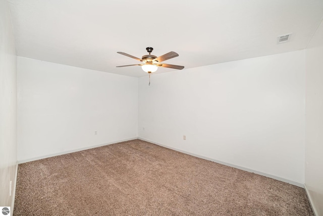 empty room featuring baseboards, light colored carpet, ceiling fan, and visible vents